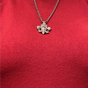Silver plated fleur de lis necklace and earrings.